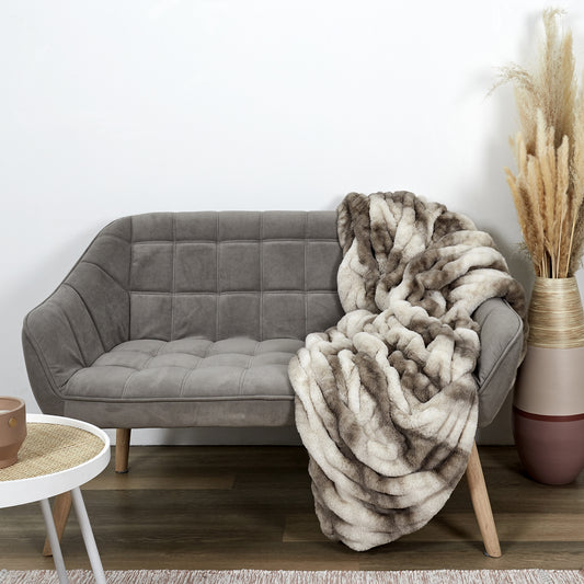 Plaid ZenPur Luxury en fausse fourrure posé sur un canapé moderne pour confort et décoration